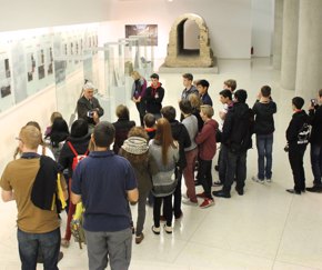 students stand and listen during a museum tour | Equity - the school travel people