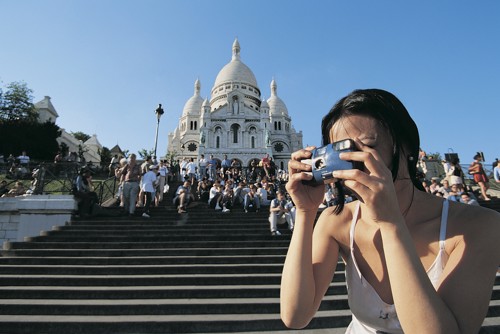 A student enjoying her disposable camera during a trip to Paris.