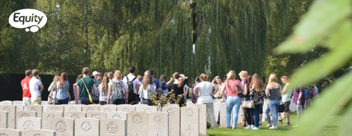 A group visit Tyne Cot Cemetery to view the graves of fallen soldiers.