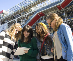 group of teenage girls with notebook | Equity - the school travel people