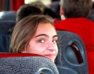 smiling female student on a coach | Equity - the school travel people