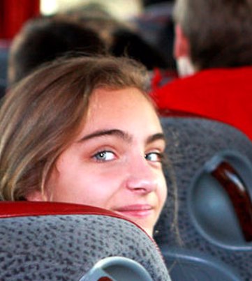 smiling female student on a coach | Equity - the school travel people
