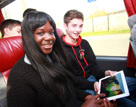 female and male student smiling at the camera as they travel by coach | Equity - the school travel people