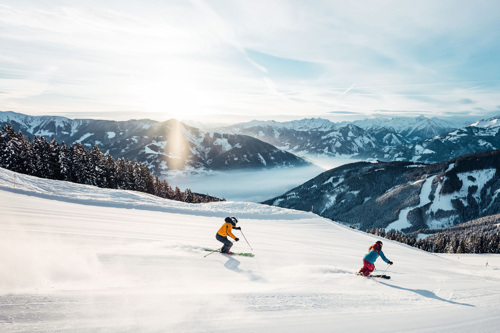 Skiers enjoying the wide open slopes of Zell am See, Austria