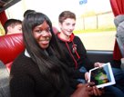 female and male student smiling at the camera as they travel by coach | Equity - the school travel people