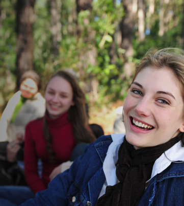 group of female students smiling in nature | Equity - the school travel people