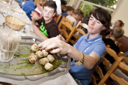 Students trying garlic snails during a food technology workshop