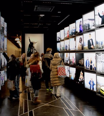 students walking through screen wall in a photography gallery | Equity - the school travel people