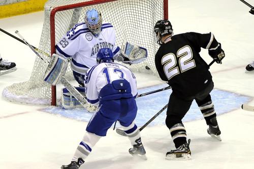 Ice Hockey players about to score a goal