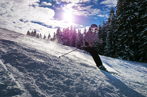 A girl skiing under sunny skies