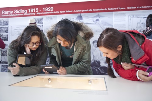 Students reading paper material artefacts at a museum in Ypres.